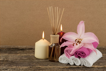 Beautiful composition with burning candles and aromatic oil on wooden background, spa and wellness concept
