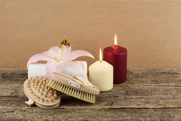 Beautiful composition with candles and massage brushes on wooden background, weight loss and body care concept