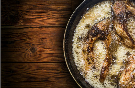 Fish In A Frying Pan. Horizontal View From Above. On The Wood