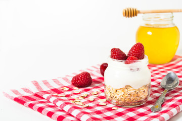 Overnight oatmeal with yogurt and raspberry on the checkered tissue