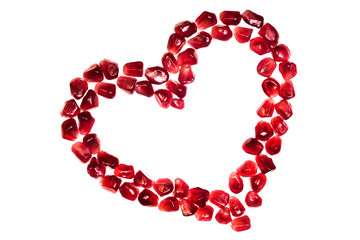 Heart from pomegranate seeds isolated on white background