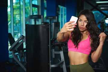 Fototapeta na wymiar Woman take selfie in fitness club