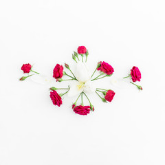 Floral background. Floral pattern made red roses on white background. Flat lay, top view