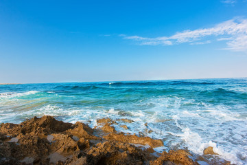 Huge wave breaking over rocks with dramatic foam and brilliant sea coast line morning,Cyprus