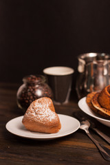 a cup of coffee cup and a cupcake on a plate