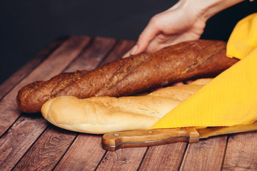 two baguettes on the table and a knife with a napkin