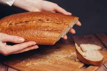 loaf on female hands, board