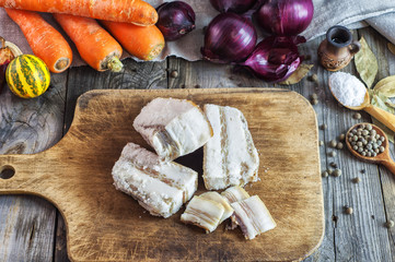 Fresh salted pork fat on a kitchen board