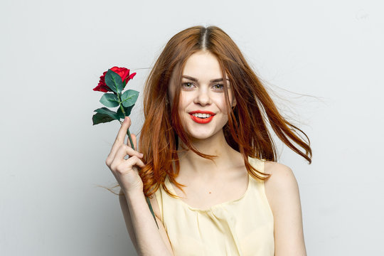 red rose on hand and happy woman, bright make-up