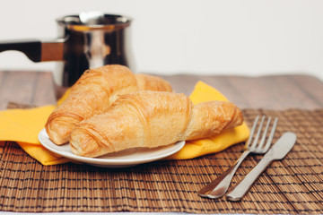 bucket in the background, croissants in a plate