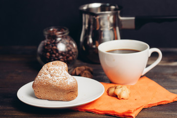 iron ladle and coffee beans in a jar, cupcake and drink in a cup