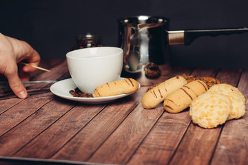 a variety of biscuits a cup of coffee and coffee beans