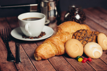 shortbread, croissants and a drink in a white cup