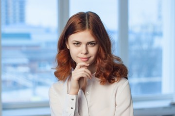Obraz premium red-haired woman, interested look, window, office