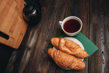 croissants and a cup with a drink, green napkin