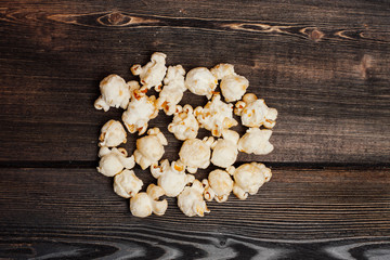 popcorn scattered on a wooden board