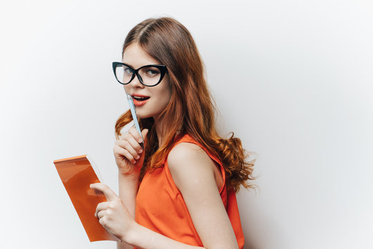 Business woman with glasses and a notepad in her hand
