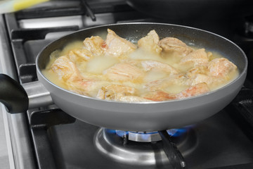 meat is fried on a frying pan