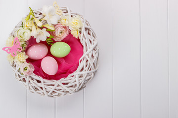 Basket of easter eggs with flowers
