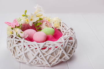 Basket of easter eggs with flowers