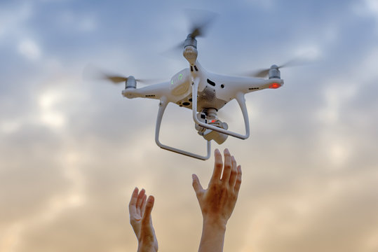 hands releasse/holding drone take off to the sky