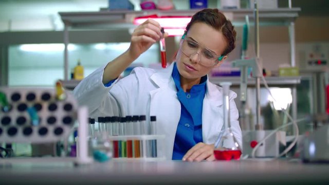 Medical scientist working in laboratory. Woman scientist medical research. Scientist carrying out scientific research in lab. Doctor scientist cure. Medical engineering. Medical researcher in lab
