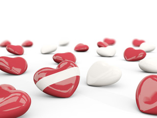 Heart with flag of latvia isolated on white