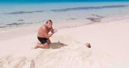Fototapeta na wymiar Young adolescent, teenage boy playing with little girl on tropical beautiful beach near the ocean 