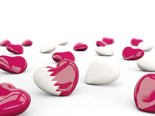 Heart with flag of qatar isolated on white