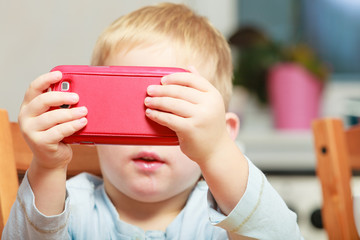 Little boy using smartphone playing games