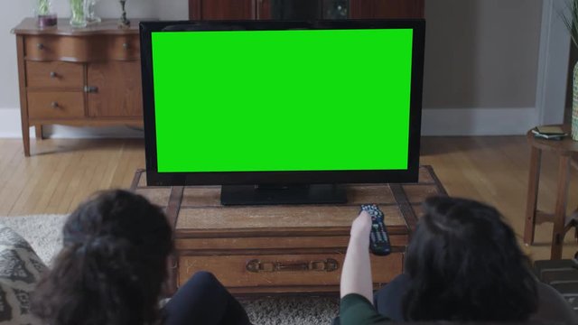 Green screen big screen with two young ladies in the foreground