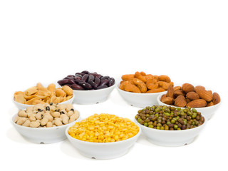 Almond, Cashew nuts, yellow bean, green bean, rice, fettucine, all put on small white cup and on white background