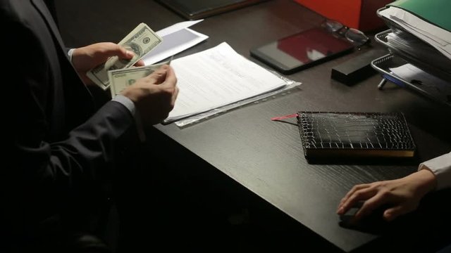 corruption, bribery and fraud concept - close up of businessman taking money