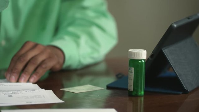 African American man checks drug costs in close up