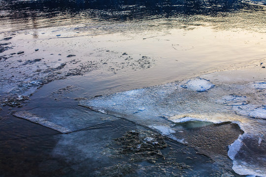 River surface covered with melting ice