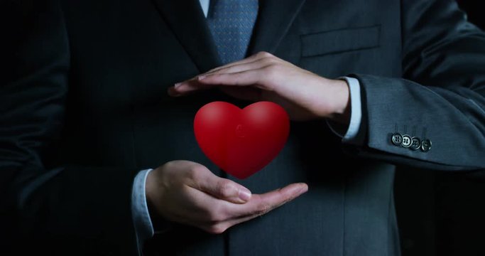 heart growing in the hands of an experienced seller or bank or insurance broker. concept for investment and passive income for retirement and annuities also health insurance concept or bank 