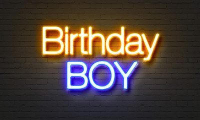 Birthday boy neon sign on brick wall background.