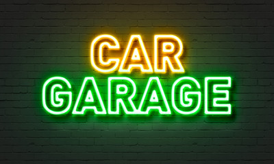 Car garage neon sign on brick wall background.