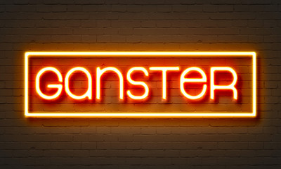 Gangster neon sign on brick wall background.