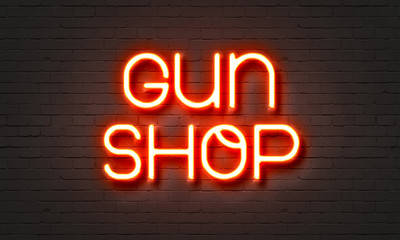 Obraz na płótnie Canvas Guns hop neon sign on brick wall background.