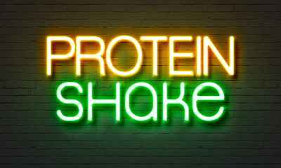 Obraz premium Protein shake neon sign on brick wall background.