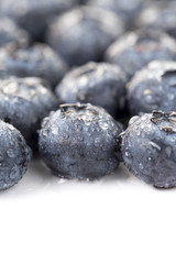Closeup of  fresh blueberry and waterdrops on the white background
