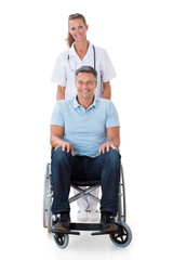 Fototapeta na wymiar Female Doctor With Patient On Wheelchair