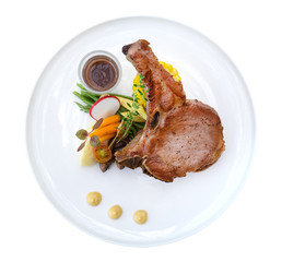 Grilled Pork Chops steak in ceramic plate isolated on white background, clipping path included