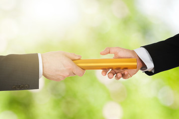 Two Businessman's Passing A Golden Relay Baton