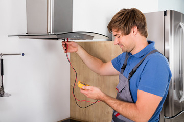 Repairman Checking Kitchen Extractor Filter