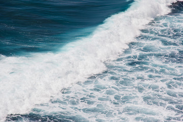 Fototapeta na wymiar Indian ocean texture. Turquoise sea water with white foam. Powerful and peaceful nature concept.