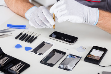 Person's Hand Repairing Cellphone