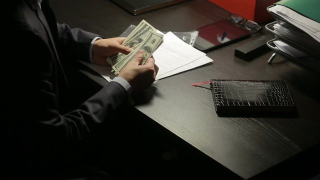 corruption, bribery and fraud concept - close up of businessman taking money