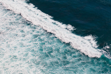 Indian ocean texture. Turquoise sea water with white foam. Powerful and peaceful nature concept.